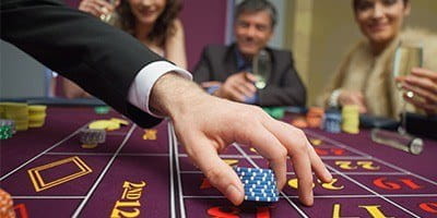 Casino guests gambling on a casino floor.