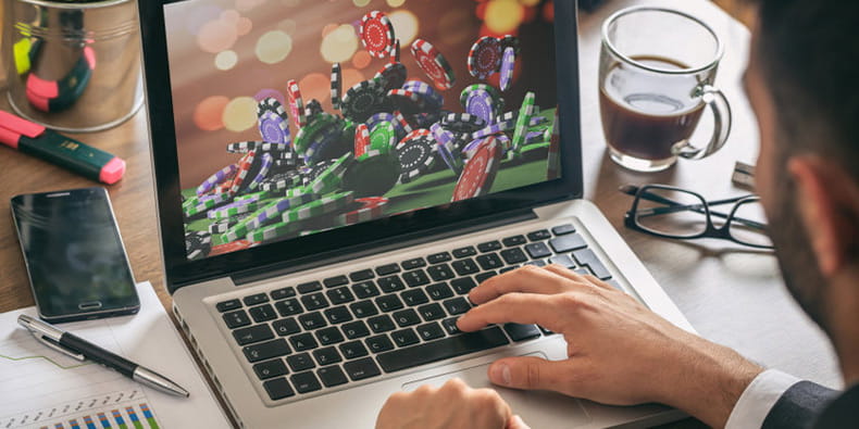 Man Playing Online Blackjack with Strategy