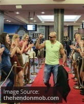 Poker player Ghanim Dashti walks down a red carpet.