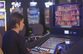 Player at Book of Ra Real Slot Machine at a Casino