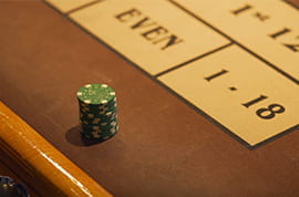 Green Casino Chips at a Roulette Table
