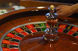 Dealer Throws the Ball in a Roulette Wheel