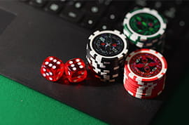 Dice and Casino Chips on a Laptop