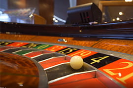 Roulette Ball on a Winning Number Four with a Casino Background