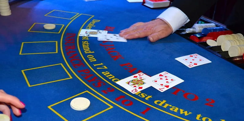 A Blue Blackjack Table with Multiple Hands on It.