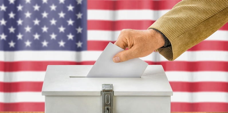 A Person Dropping an Envelope into the Ballot Box