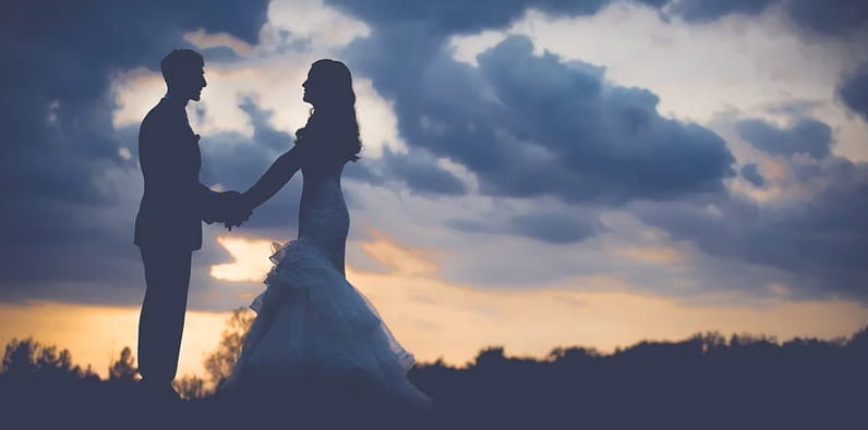 Bride and Groom Holding Hands at Sunset