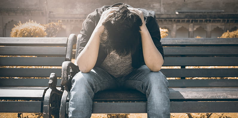 Man Struggles On a Bench