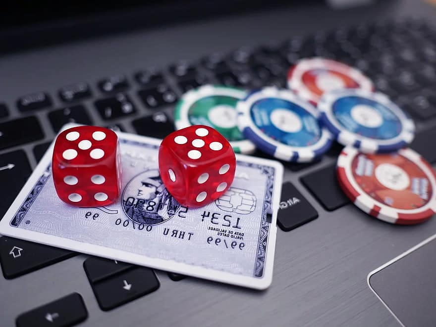 Casino Chips, Lottery Tickets and Cards Placed on a Laptops Keyboard 