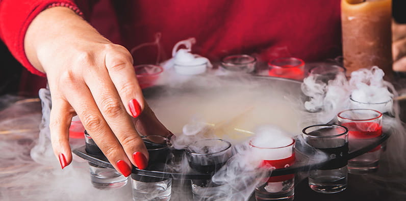 A Female with Red Nails Playing Drinking Roulette Game