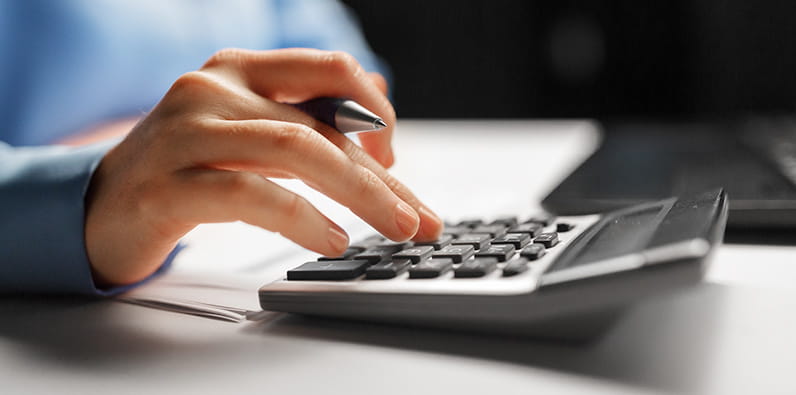 Accountant Calculating with a Calculator