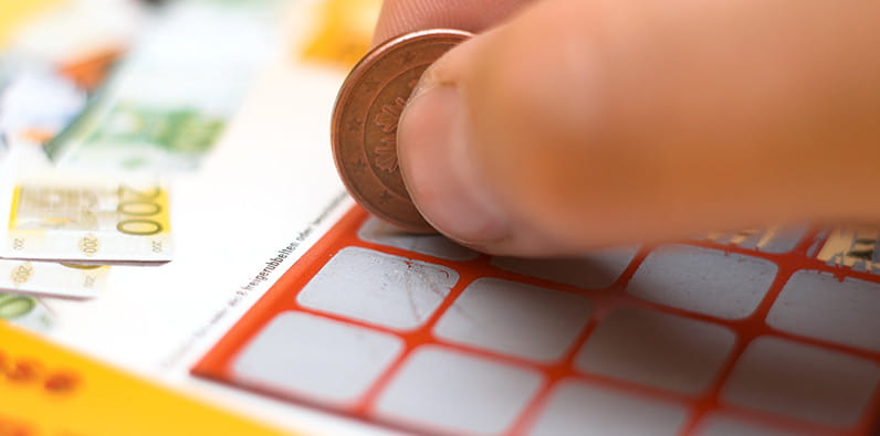 Person Scratching Lottery Card