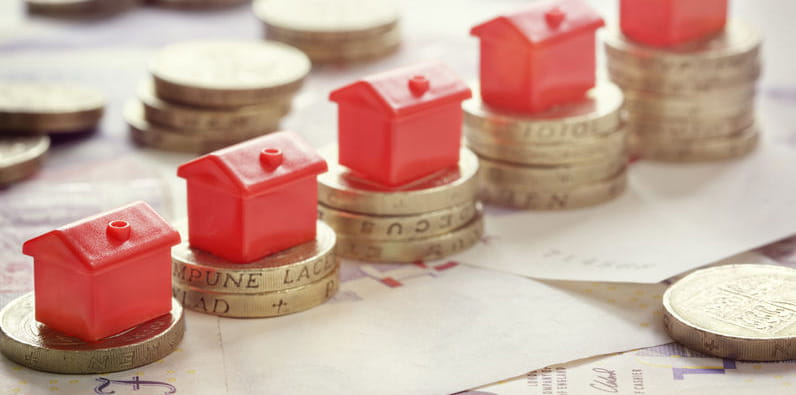 Piles of Coins with Houses On Top