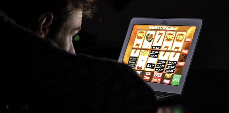 A Man Gambling Online On His Laptop