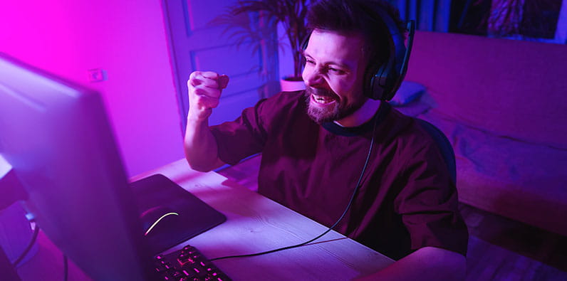 Man Cheering Up Behind his Computer