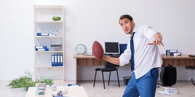 Man in Suit Playing Ball in His Office.