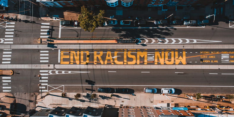 End Racism Now Written on the Road