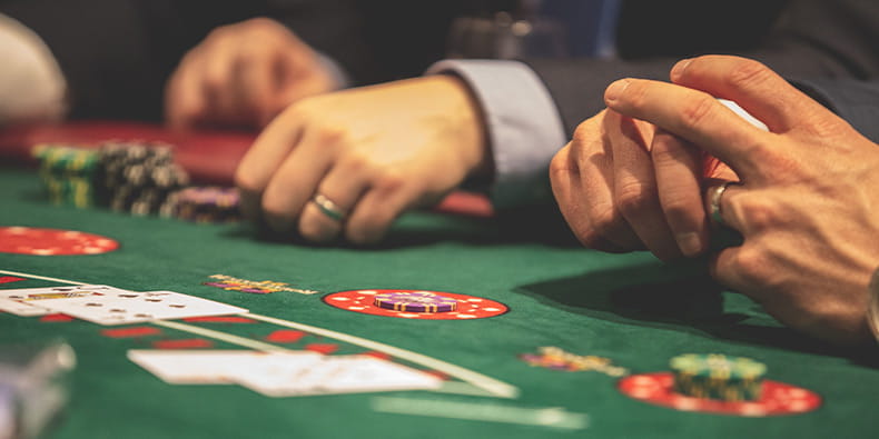 Several Gentlemen Playing Blackjack in Casino
