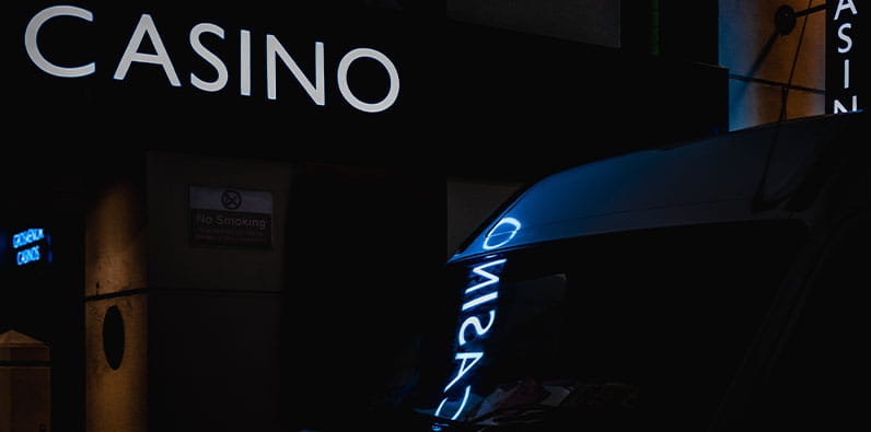 A White Casino Sign Reflected on a Car Windshield
