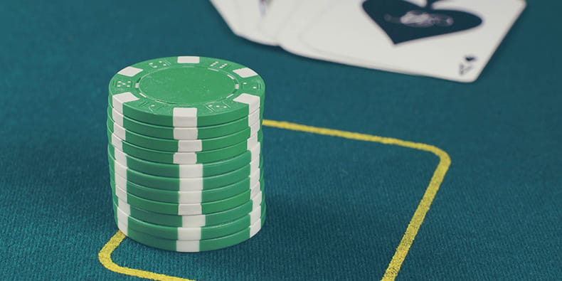 Green Chips and Cards on a Casino Table 