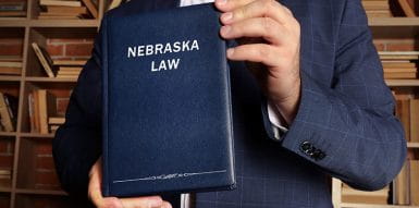  Nebraska Gambling Laws Books Held by a Person in a Suit
