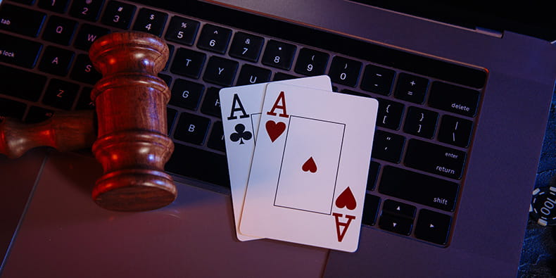 A Gavel and Casino Cards on a Laptop Keyboard