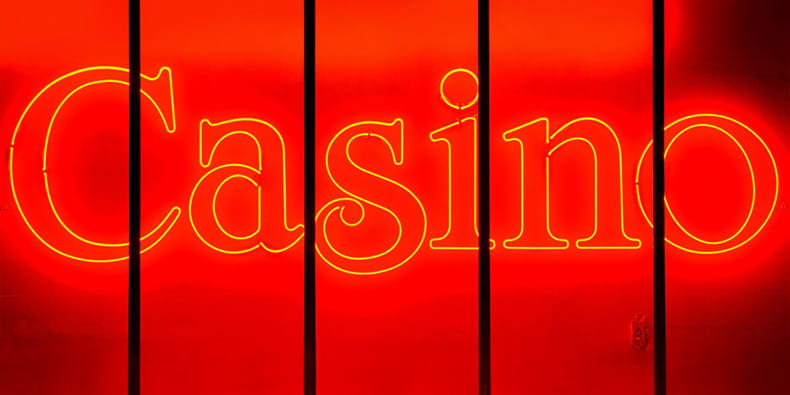 Neon Casino Sign Over Red Background