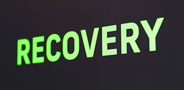 An Image With a Big Green Text, Showing nan Word "Recovery" 
