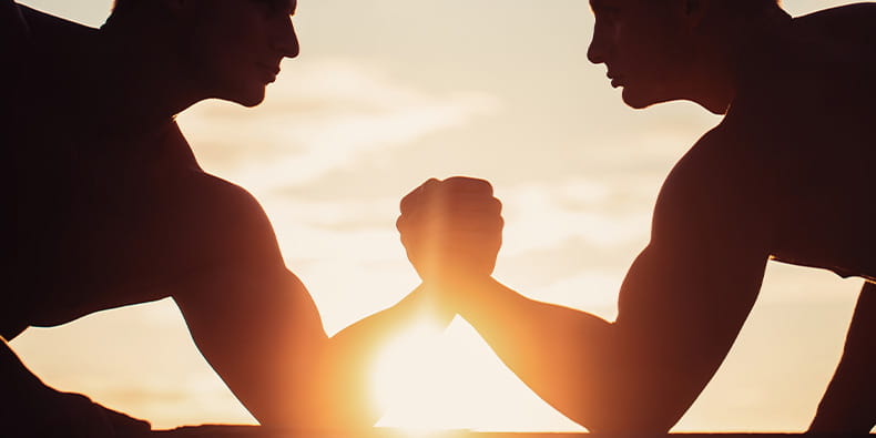 Two Men Hold Hands Competing