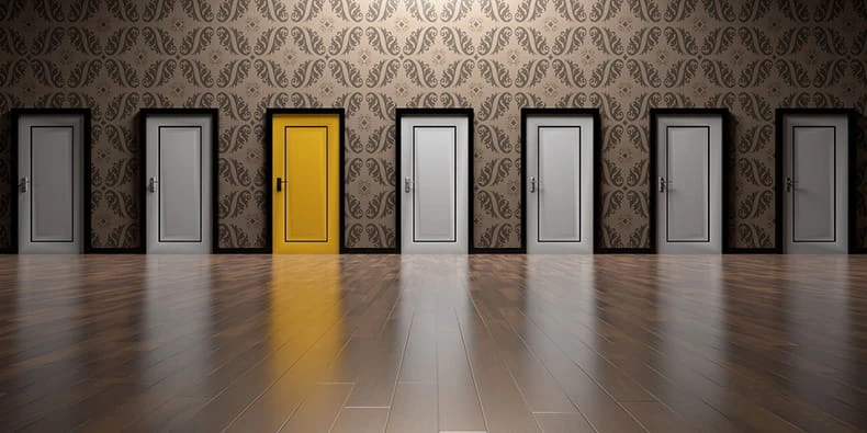 Line of White and One Yellow Doors 