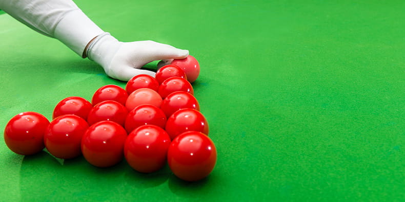 Snooker Referee Rearranging the Pink Ball on the Table