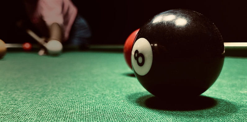 A Black "8" Snooker Ball On Top Of The Table