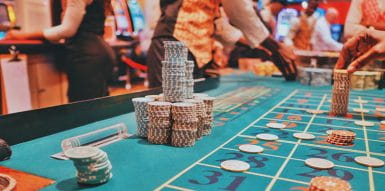  A Teal Poker Table With Chips On Top