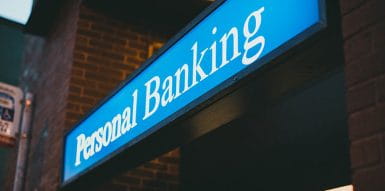  Blue sign with the phrase Personal Banking wrote on it.
