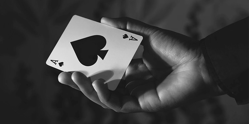 An Ace of Spades Card connected a Black Background 